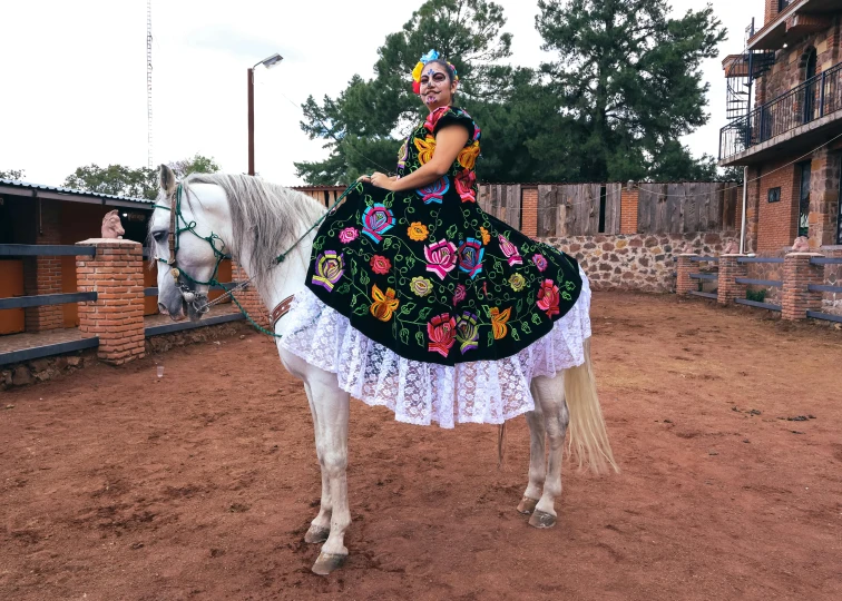 a woman riding a horse in a park