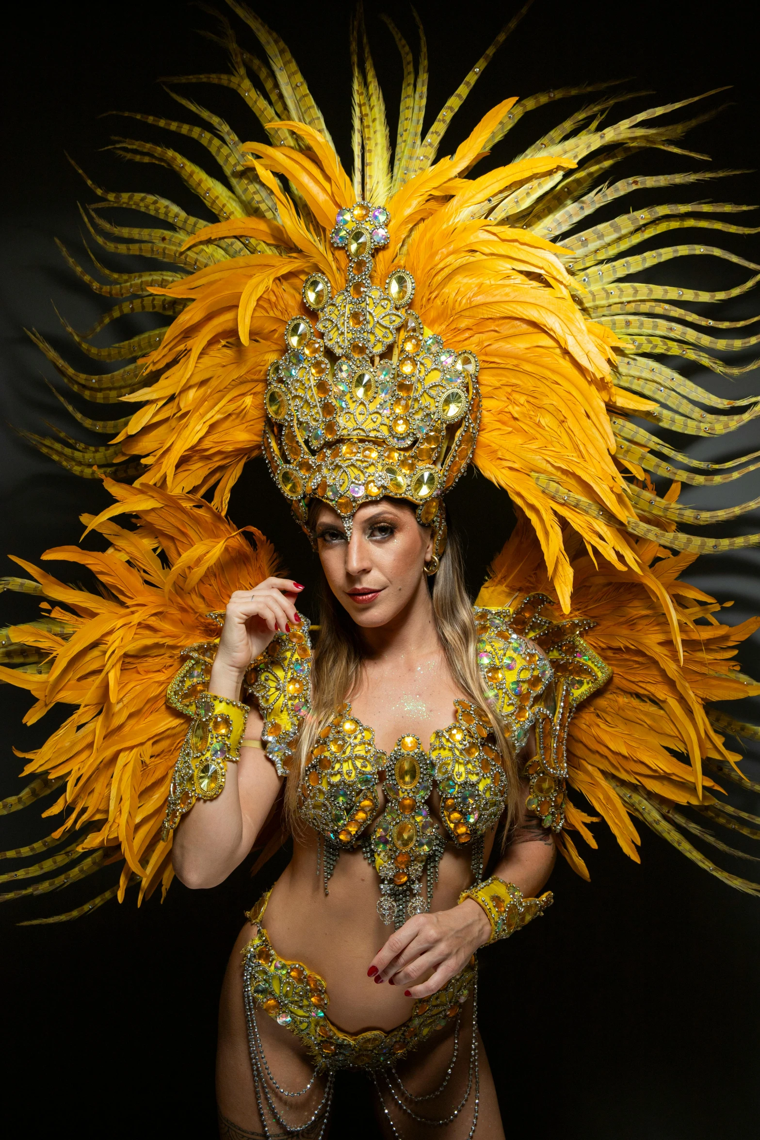 a young woman in a feathered costume posing