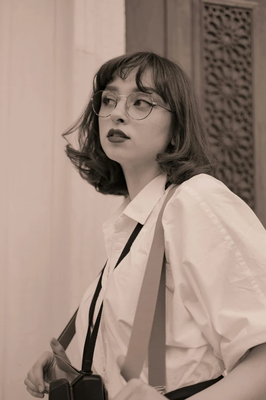 a woman standing wearing a white shirt and tie