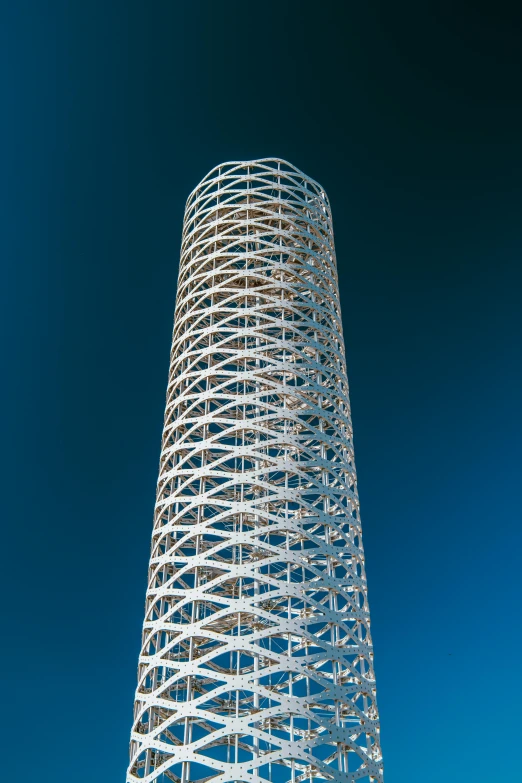 a very tall building with a metal spiral design on top