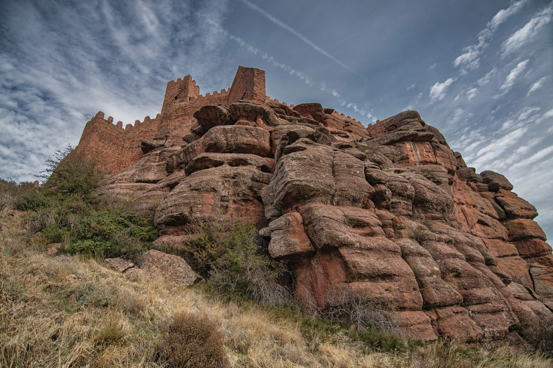 a castle in the rocks on top of a hill