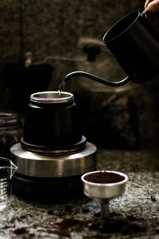 a person stirring soing with a tea pot