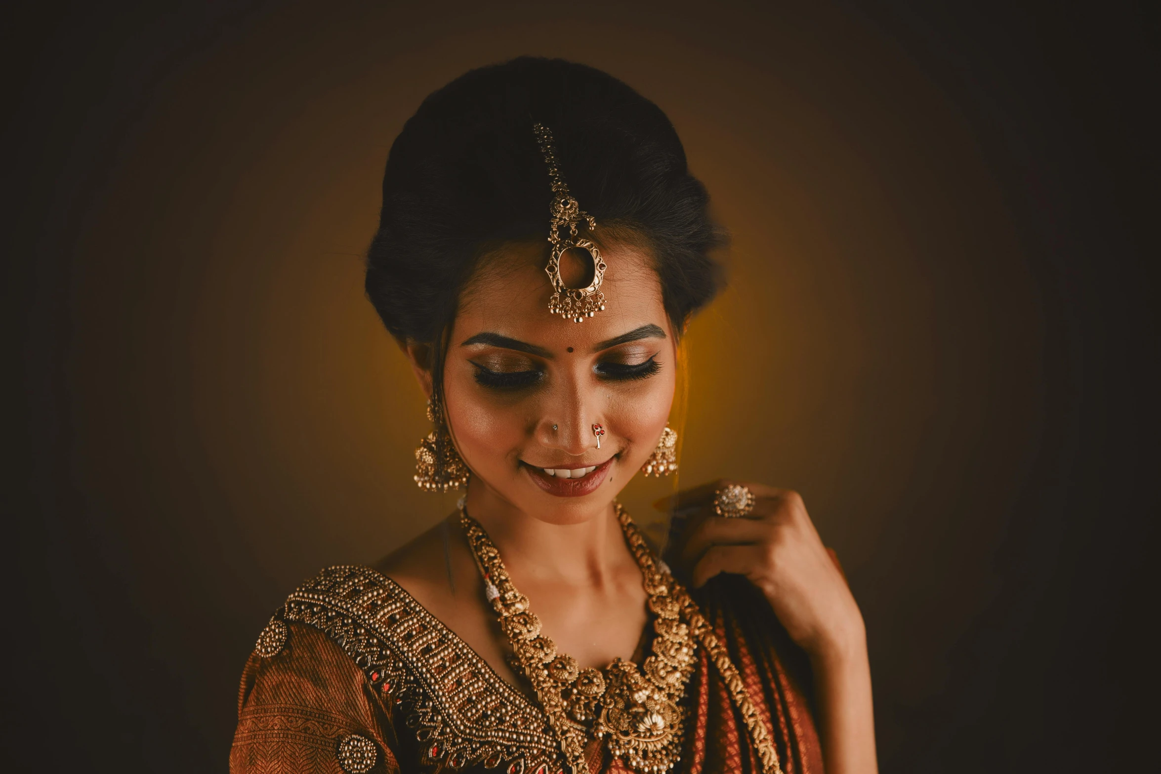 a woman is smiling and dressed in traditional attire