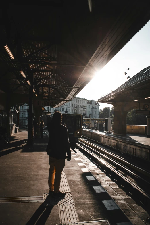 a person is walking at the train station