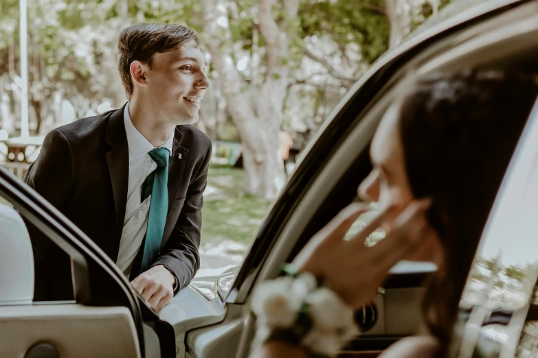 a couple getting out of a car on their wedding day