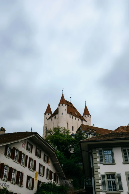 buildings with towers and two buildings under a cloudy sky