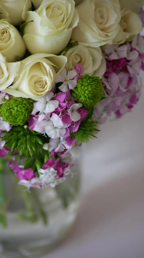 flowers are sitting in a clear vase and it is pretty