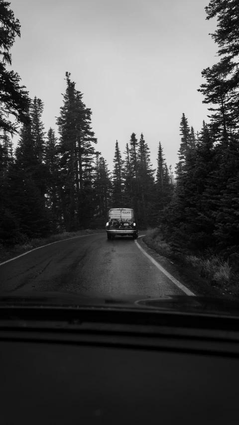 a car driving down the road in a very misty area