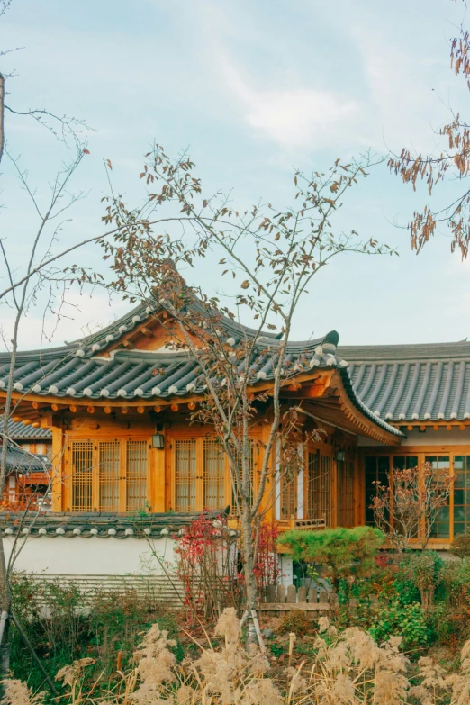 a house sits in the middle of a flower garden