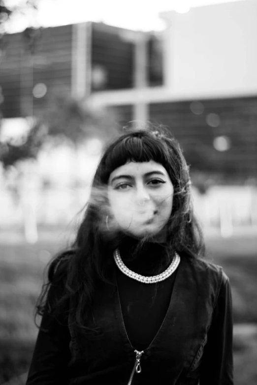 a woman with long hair blowing her nose