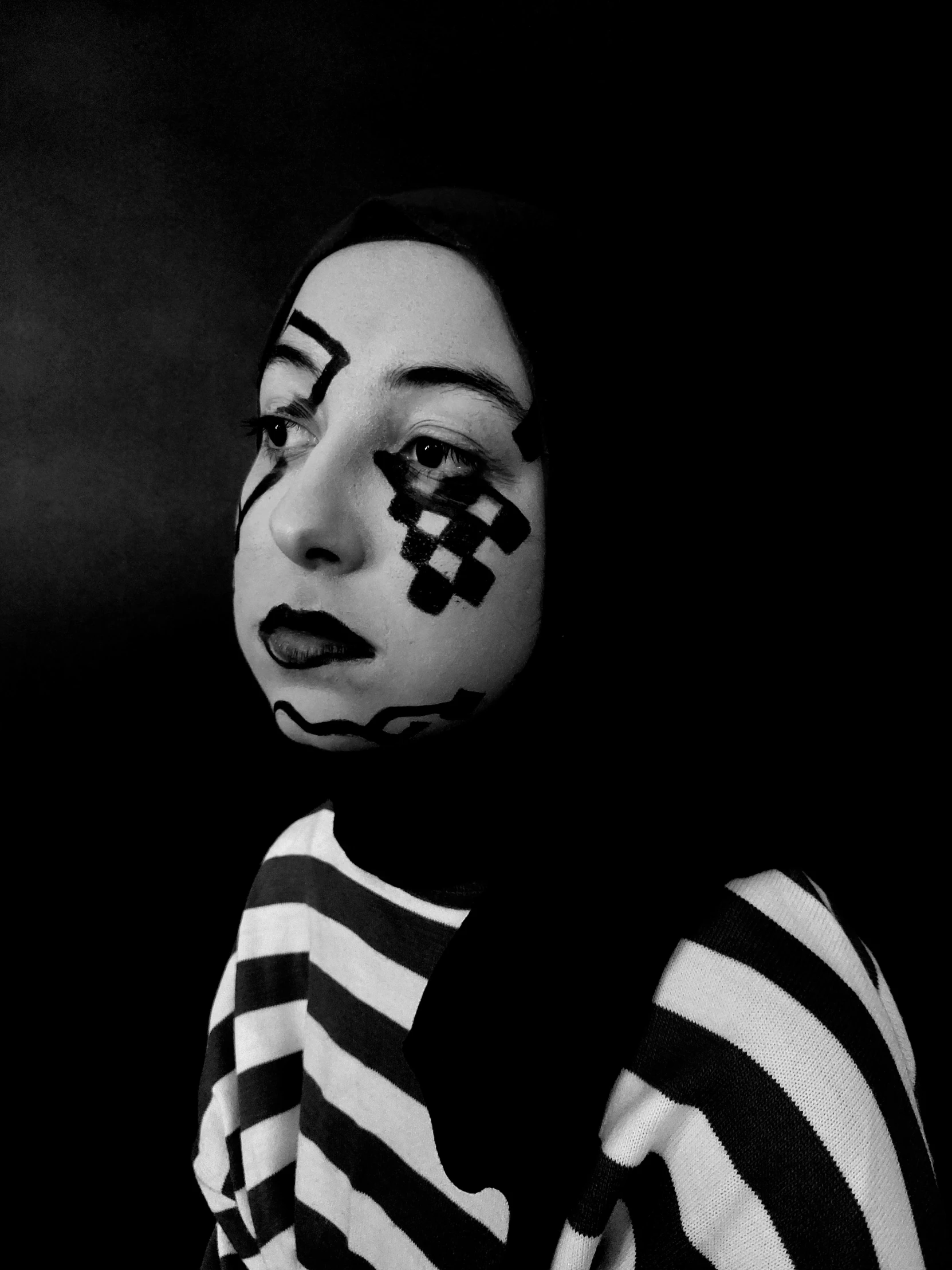 a woman with painted face in black and white