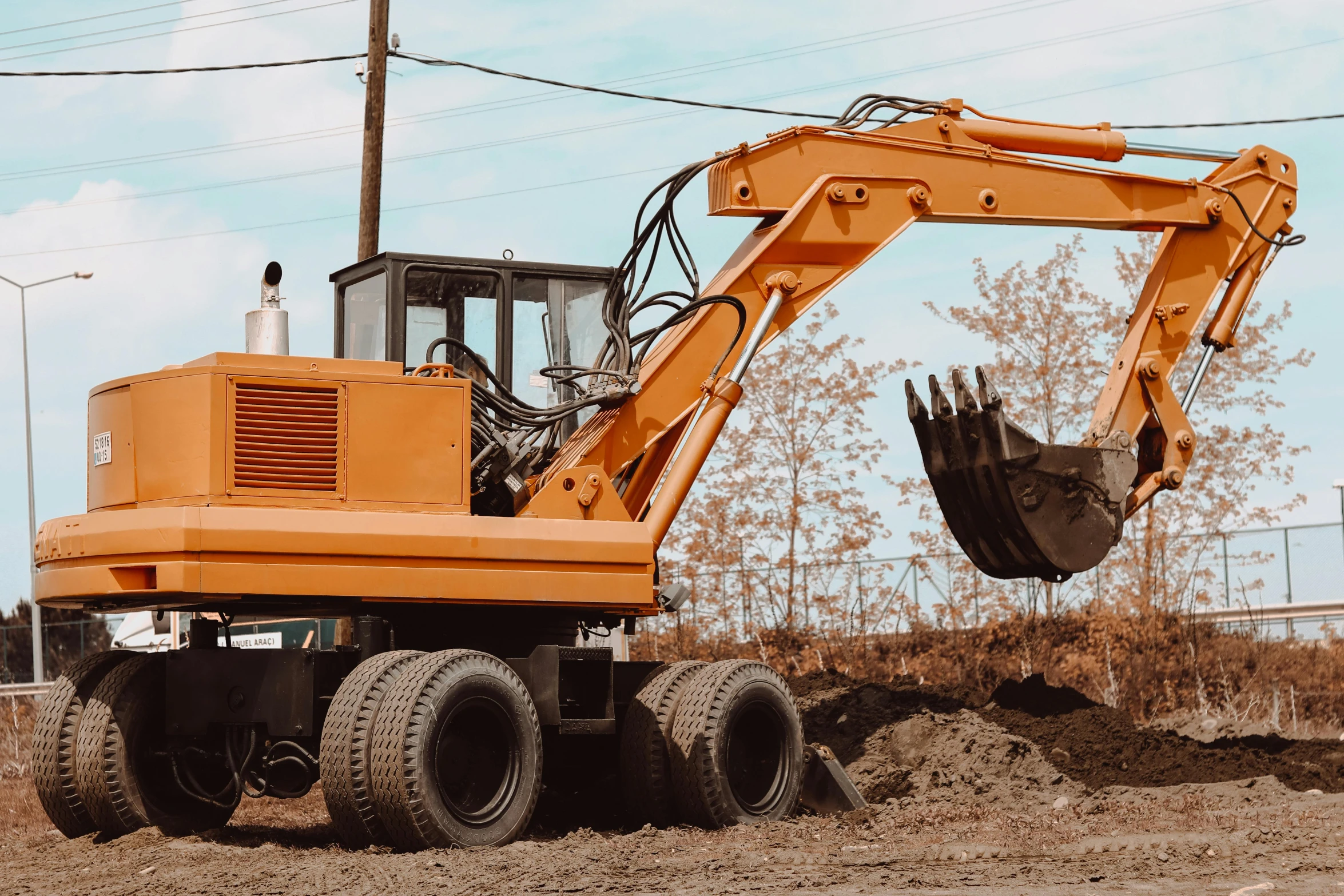 a small tractor digging in the dirt