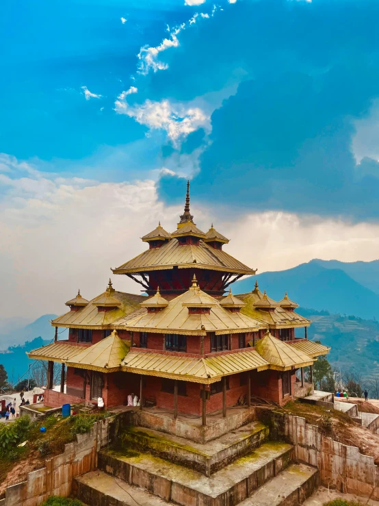 a golden pagoda on top of some steps