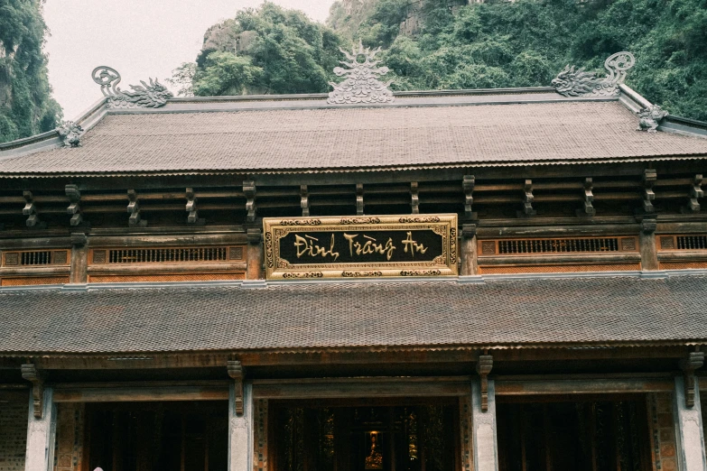 asian buildings are adorned with a gold plaque