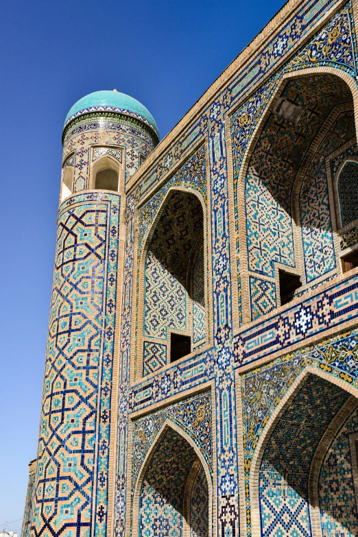 an intricate wall and roof with blue tiles on it