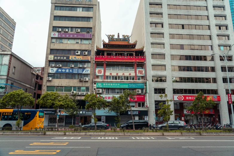 an asian style building with several buildings in the back ground