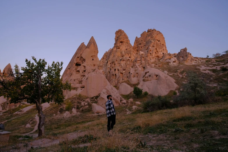 person standing on hill with mountain in the distance