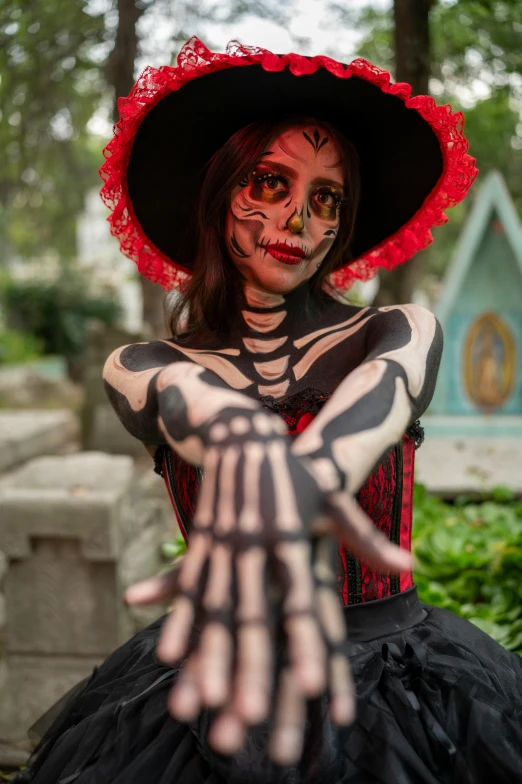 a woman in day of the dead makeup and skeleton makeup