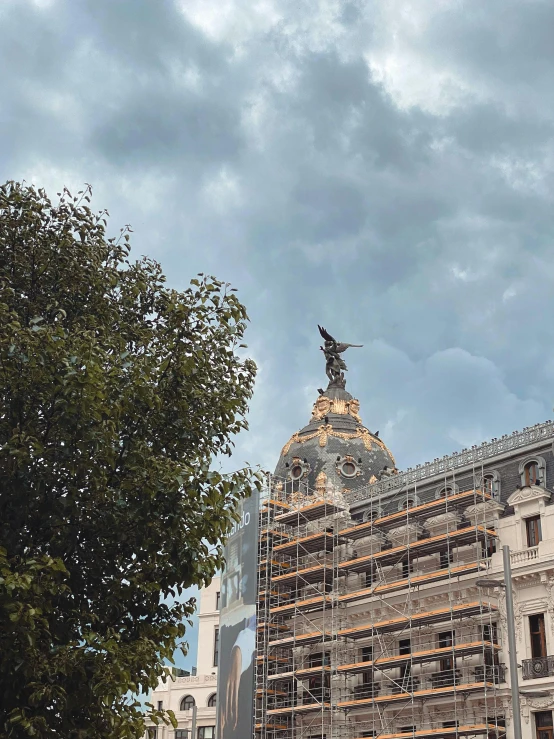 an old building with a statue on top