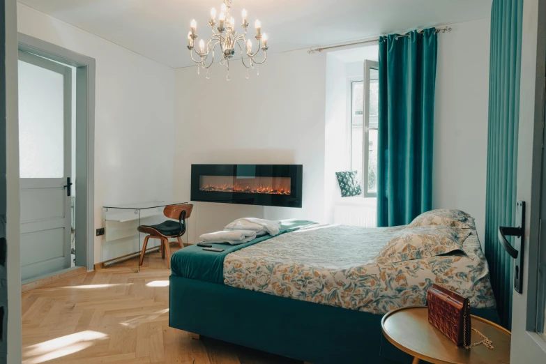 bedroom with bed, table and fireplace in background