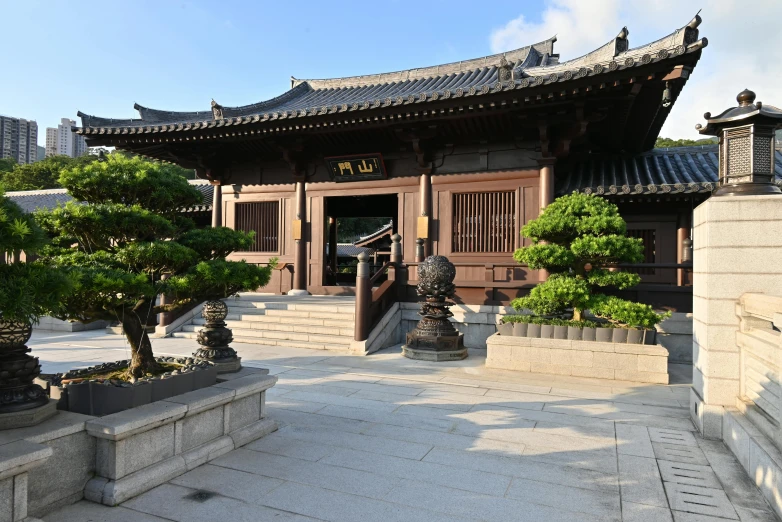 a long building with lots of plants in front of it