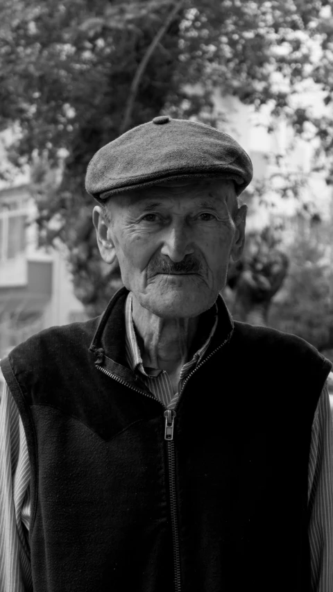 an older man with a mustache and a vest