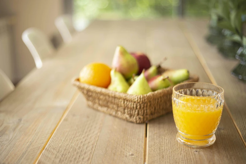 the fruit is in the basket on the table