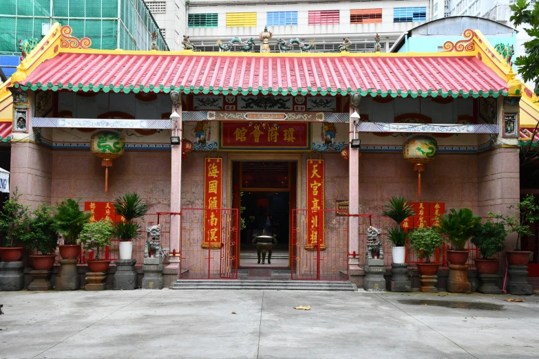 a building with red and yellow trim and doors