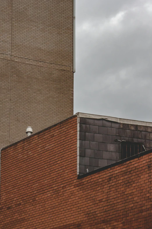 a stop sign on the top of a brick wall