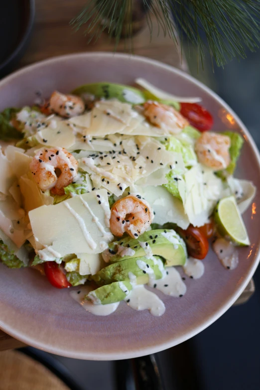 a white plate topped with lettuce and shrimp