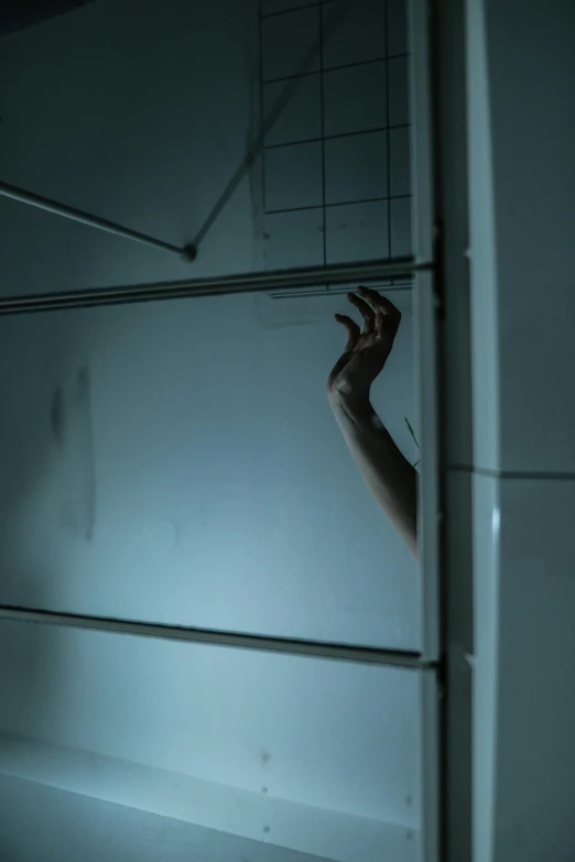 a hand reaches out from the wall in a room