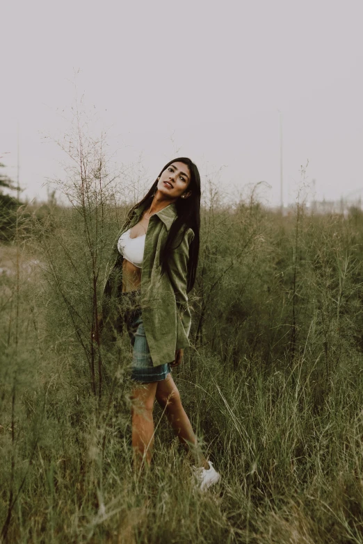 an attractive woman posing in tall grass