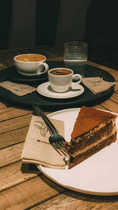 a plate with food and two cups of coffee