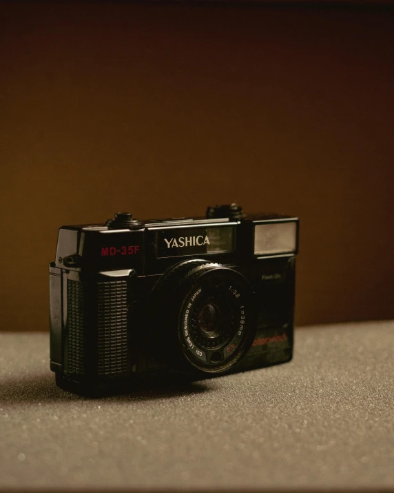 an old black camera sitting on the floor