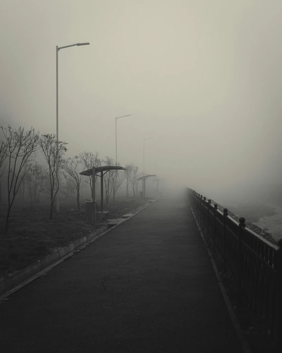 a street light with fog on the ground