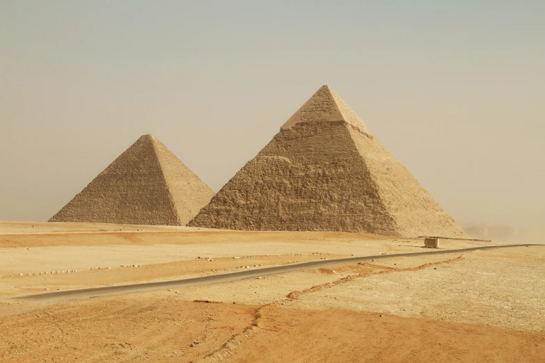 some tall tan brick pyramids in a barren area