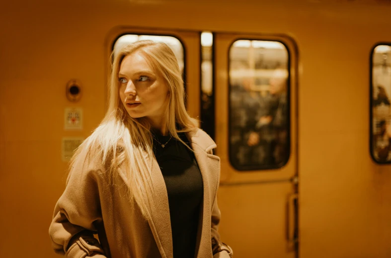 a woman standing next to a subway car