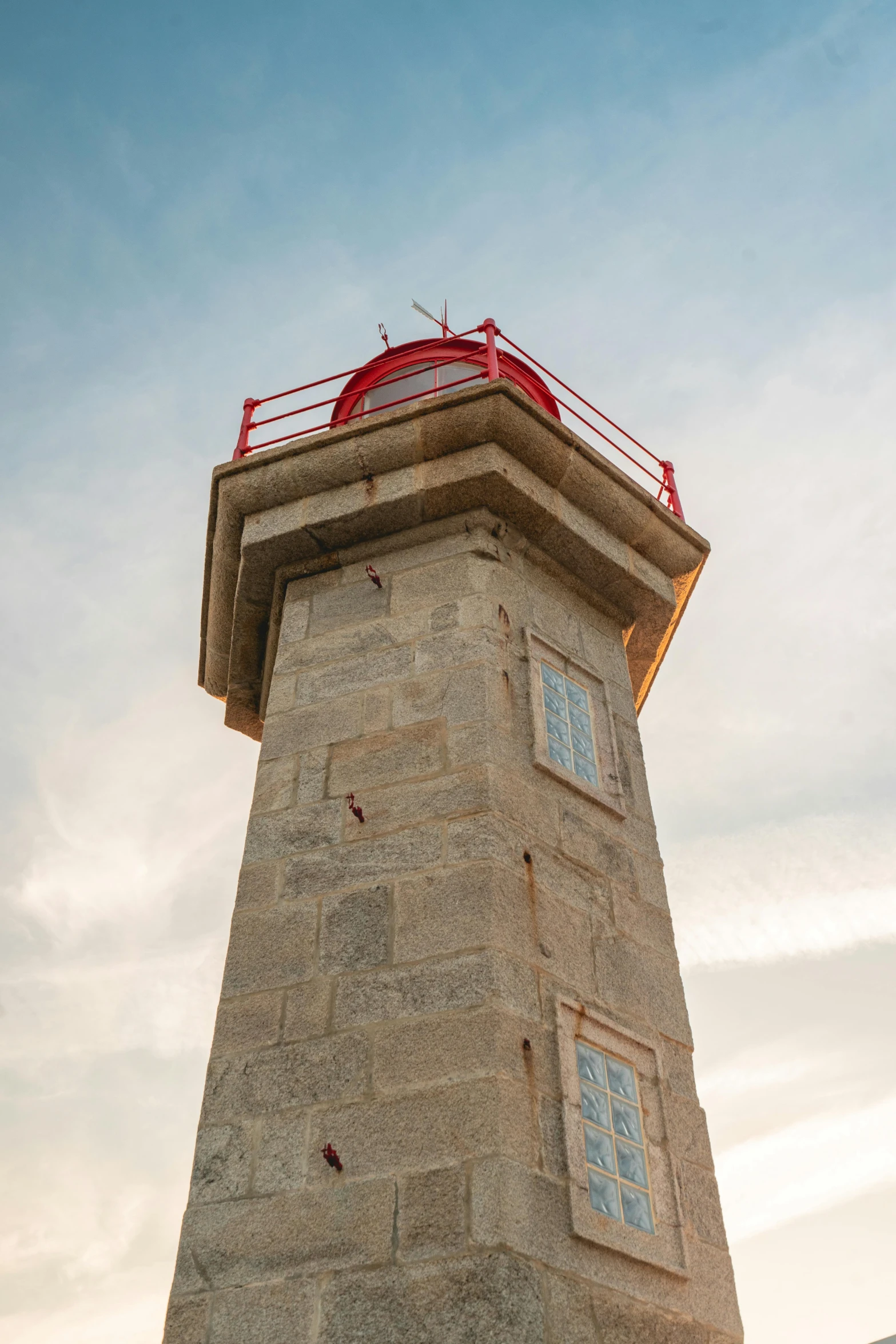 the side view of a tall tower with a weather vane