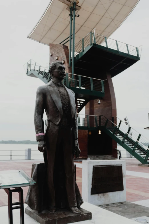 a sculpture of a man in a suit standing next to a staircase