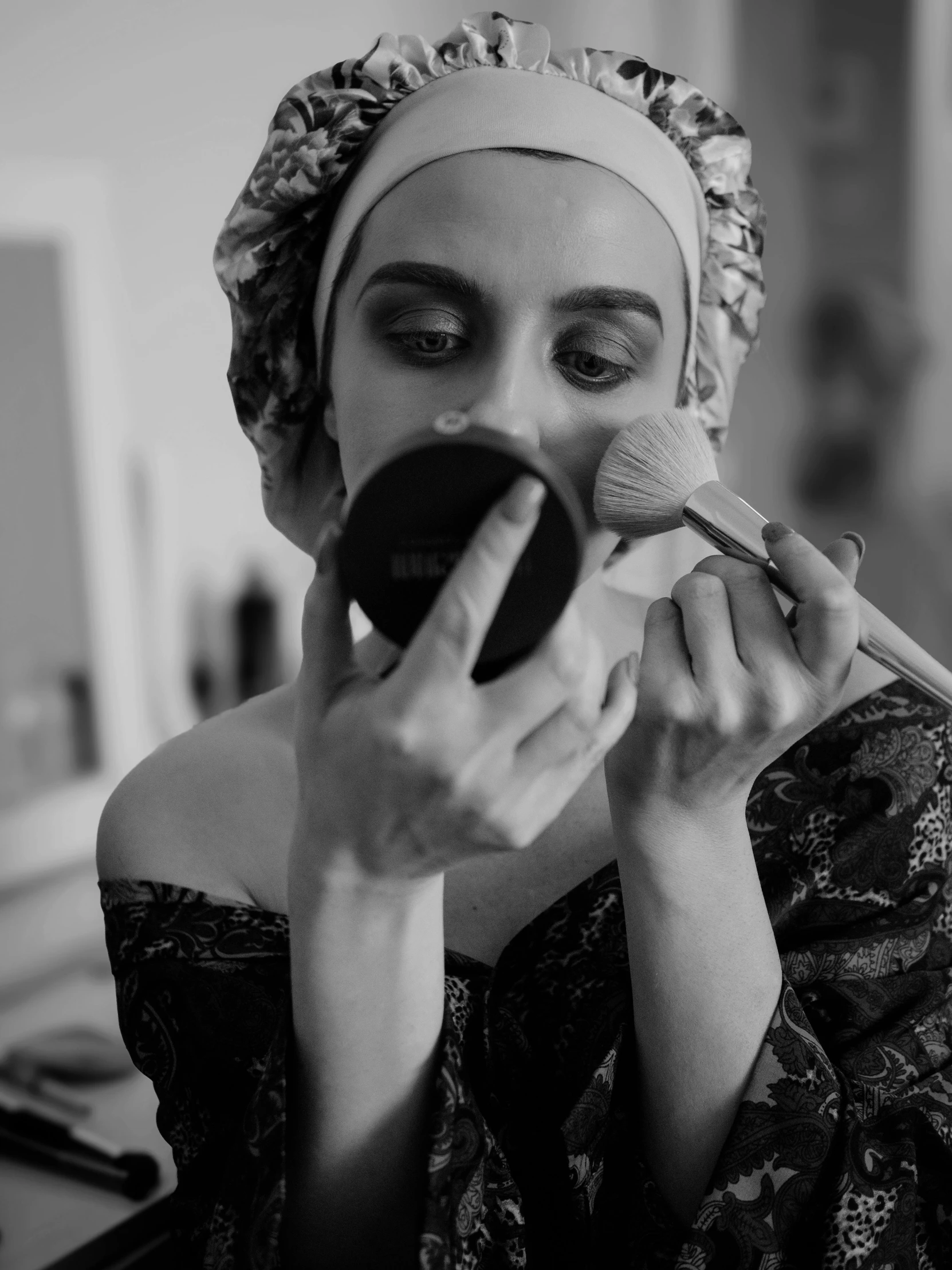 a black and white po of a woman brushing her teeth