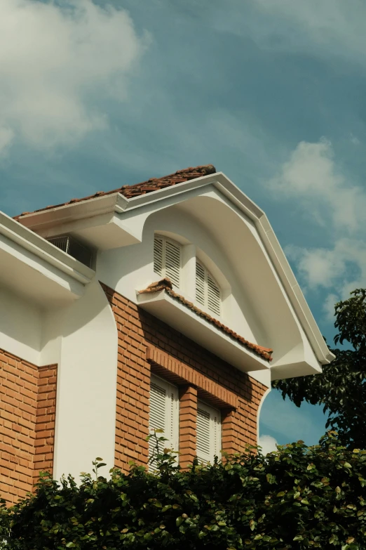 the corner of a building with plants on top