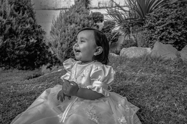 a little girl that is laying down on the ground