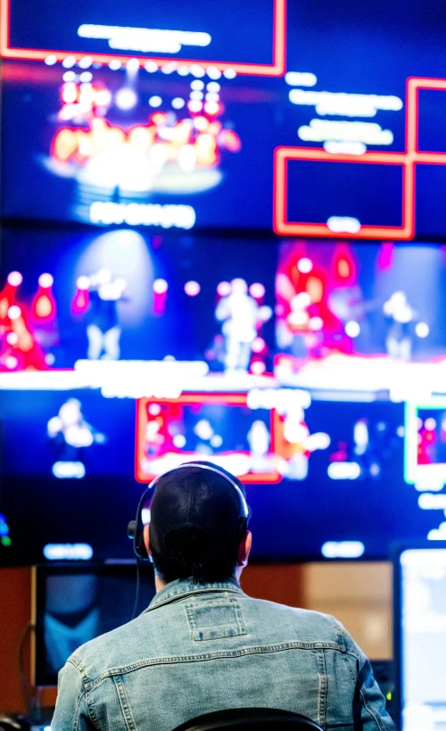 a man sits and watches a television screen