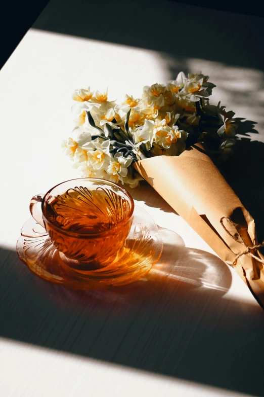 a small vase on a glass table next to a bottle