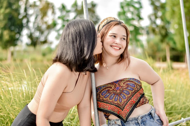 two women with very little boosies are wearing matching bikini tops