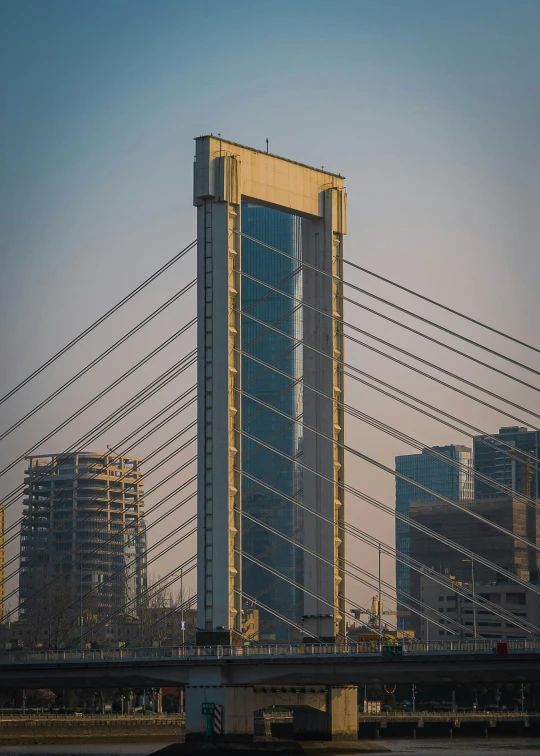 a bridge with a clock in the middle and a skyscr behind it