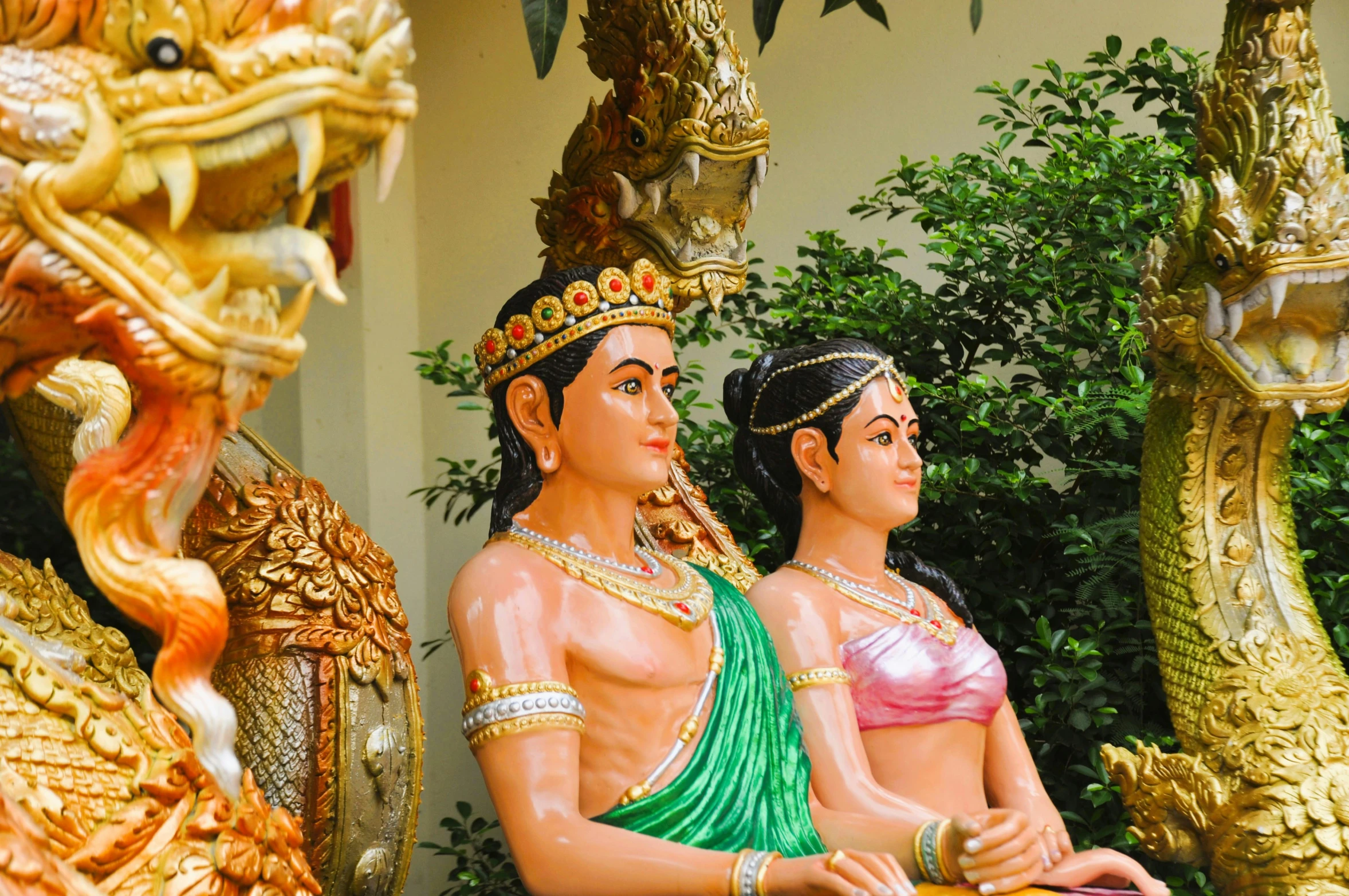 two statues of women are standing next to each other