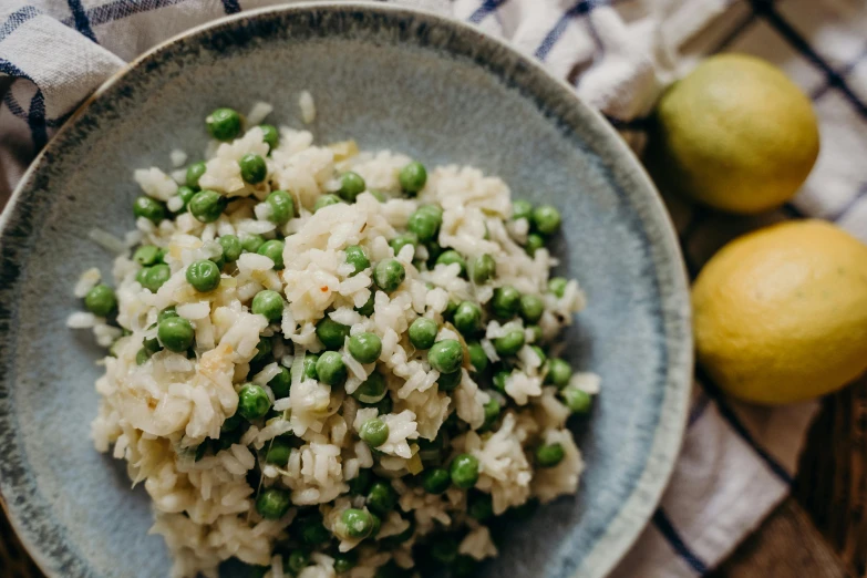 rice and peas are served with lemon wedges