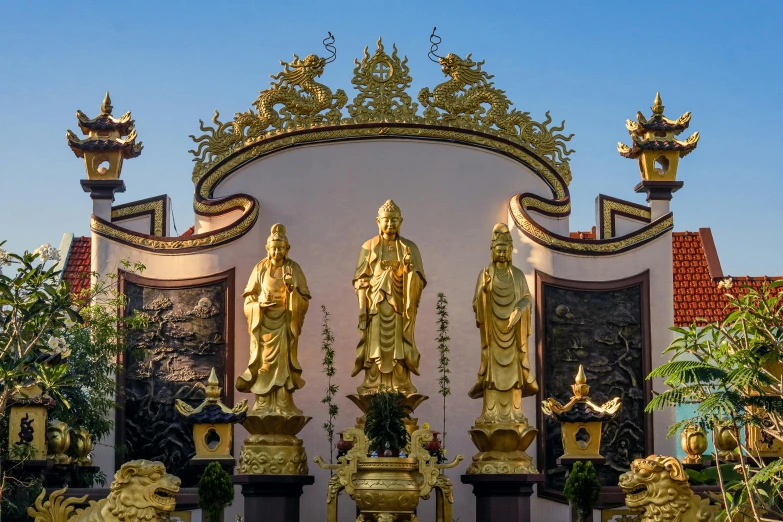 statues of buddha and other people stand around