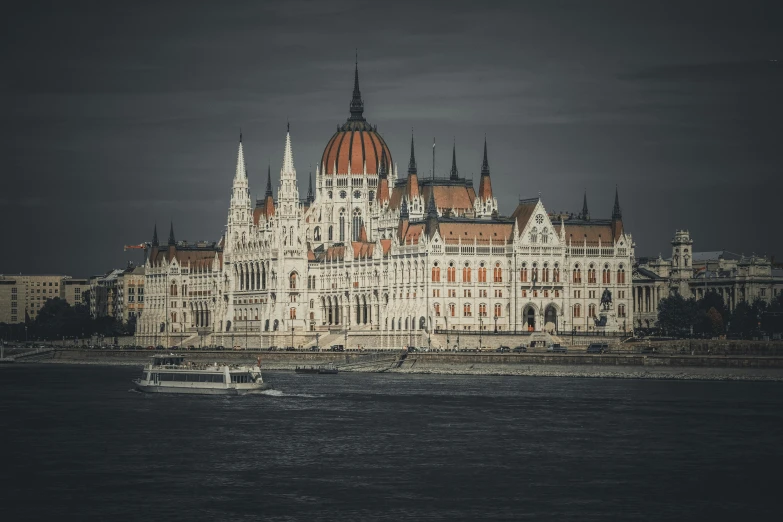 a castle on the shore with boats in front of it